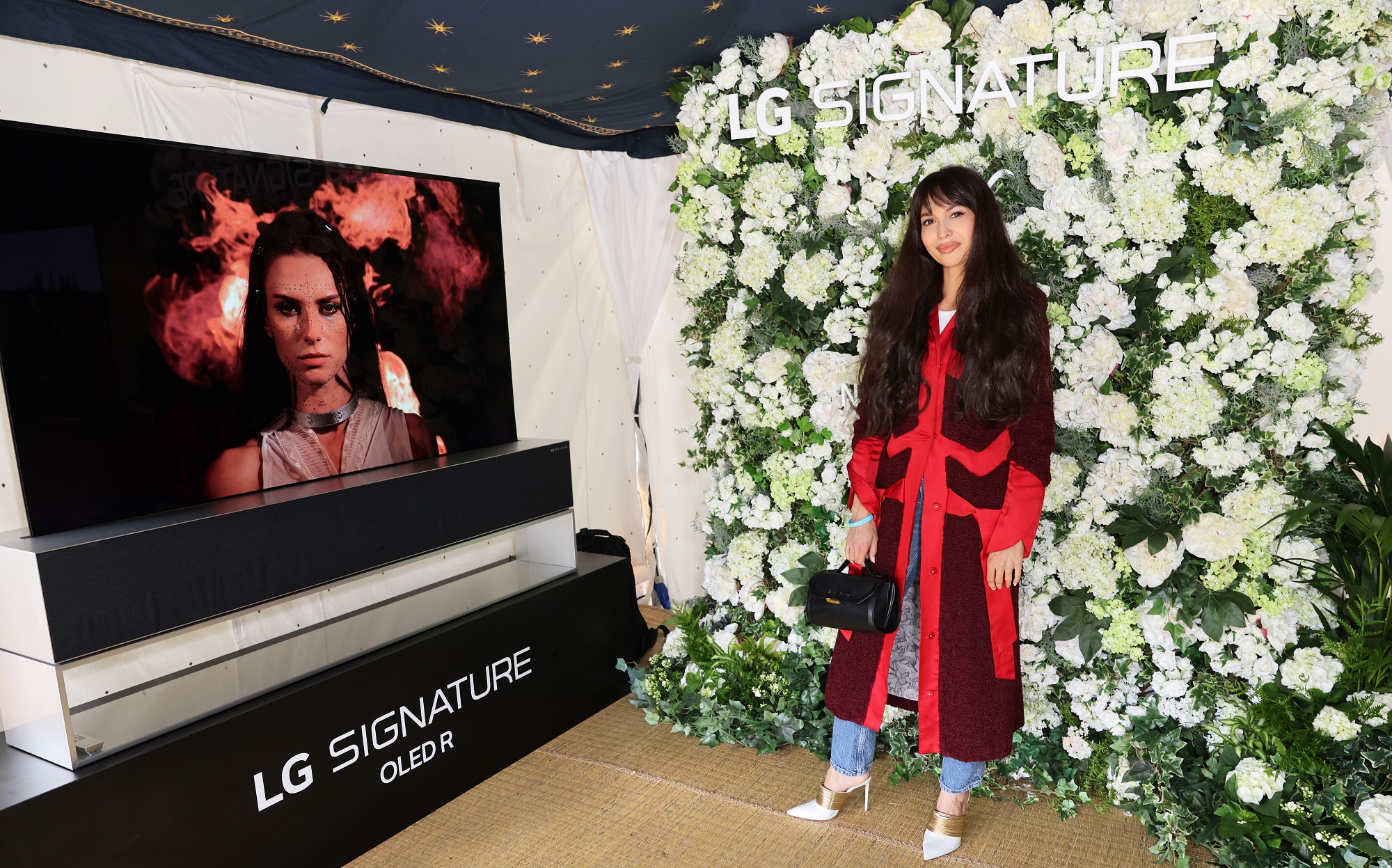 British presenter and DJ Zara Martin posing in front of LG SIGNATURE OLED R.